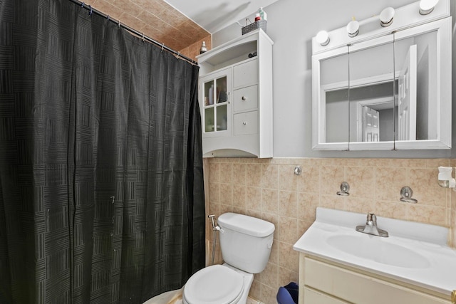 bathroom with toilet, curtained shower, tile walls, and vanity