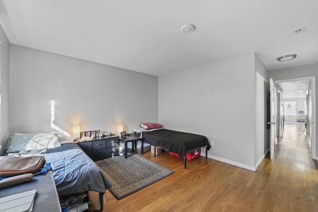 bedroom featuring baseboards and wood finished floors