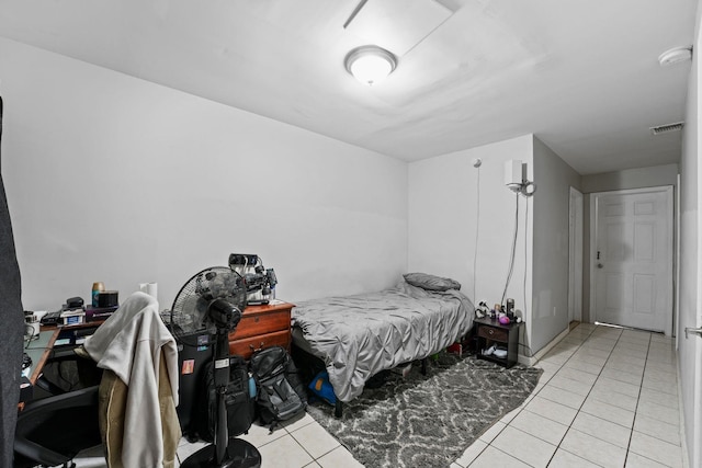 bedroom with visible vents and light tile patterned floors