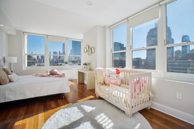 bedroom featuring a view of city and multiple windows