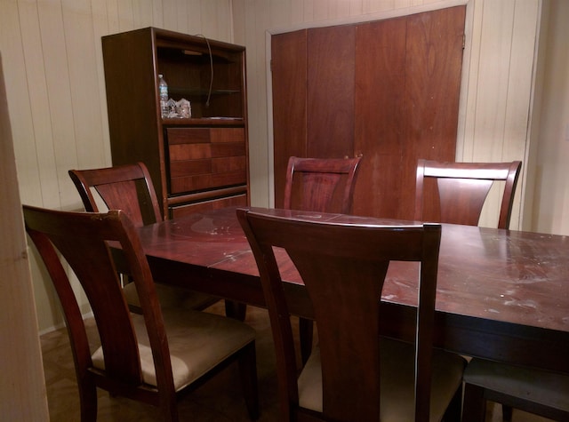 dining room with wood walls