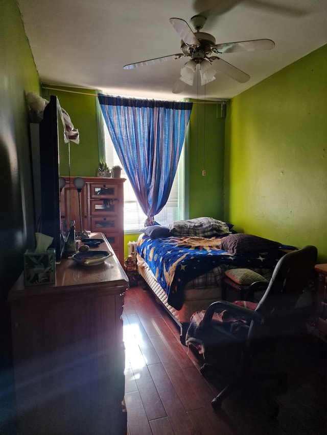 bedroom with ceiling fan and wood finished floors