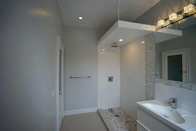 full bath with recessed lighting, tiled shower, and vanity