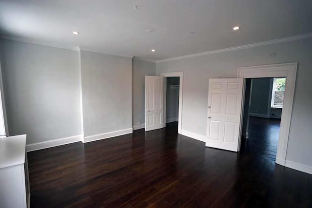 unfurnished bedroom featuring recessed lighting, crown molding, dark wood-type flooring, and baseboards