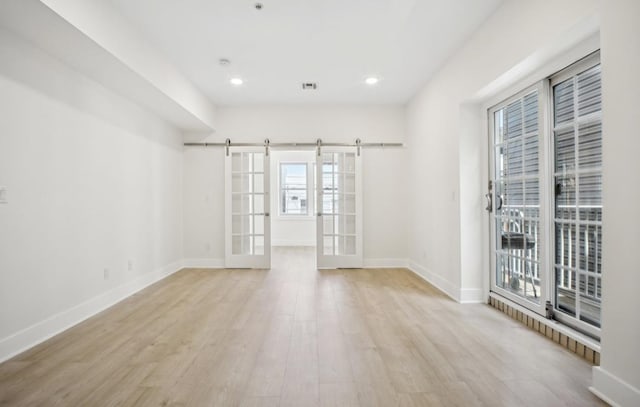 107 Laidlaw Ave Unit 2, Jersey City, NJ 07306 - empty room with a barn door, wood finished floors, baseboards, french doors, and recessed lighting