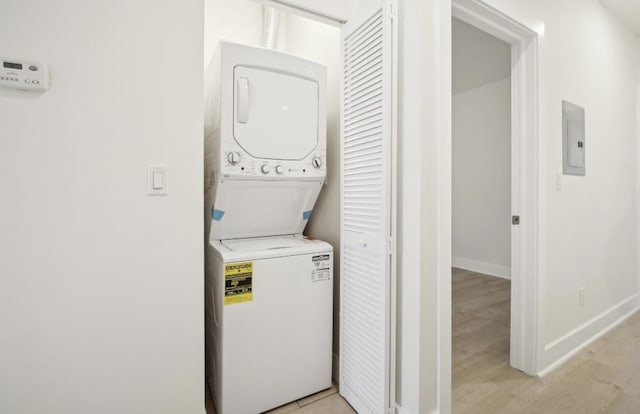 107 Laidlaw Ave Unit 2, Jersey City, NJ 07306 - laundry area with stacked washer and clothes dryer, light wood finished floors, baseboards, and electric panel