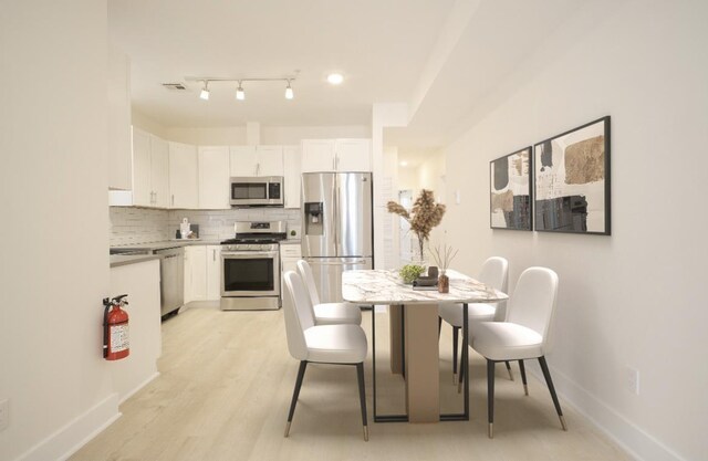 107 Laidlaw Ave Unit 2, Jersey City, NJ 07306 - dining space featuring baseboards and light wood-type flooring