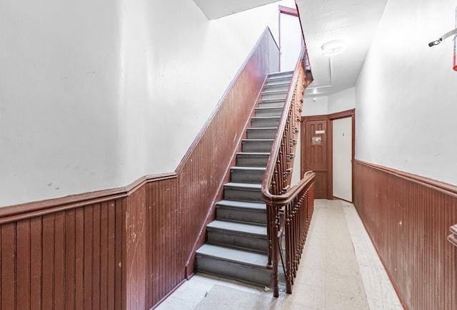 stairway with wood walls