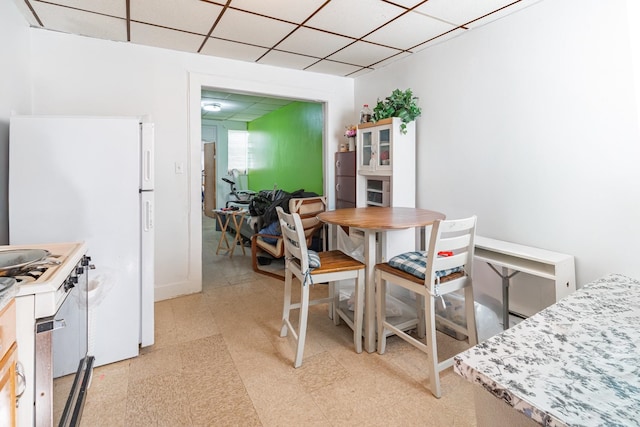 dining area with a paneled ceiling