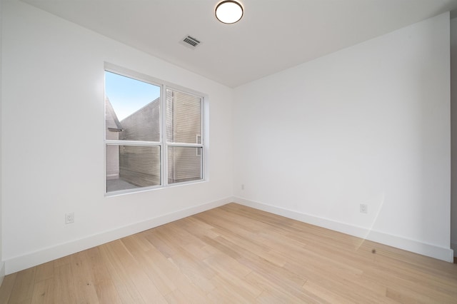 unfurnished room with light wood-type flooring