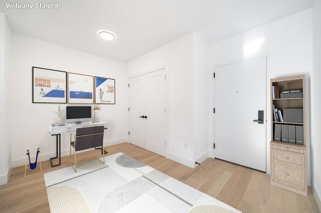 home office with wood-type flooring