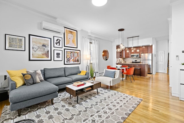 living area with light wood-style flooring, ornamental molding, and a wall unit AC