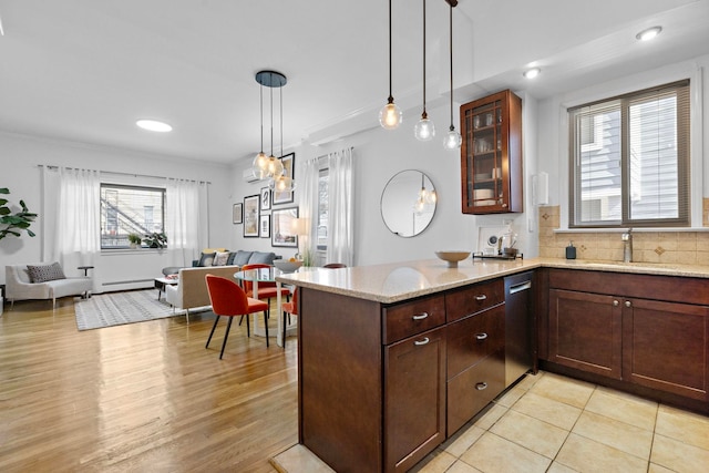 kitchen with a sink, tasteful backsplash, a peninsula, glass insert cabinets, and dishwasher