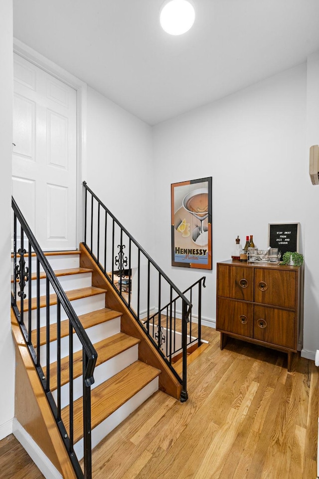 stairs featuring baseboards and wood finished floors