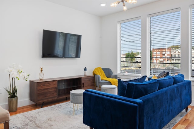 185 Gates Ave, Jersey City, NJ 07305 - living room with a chandelier, wood finished floors, and a healthy amount of sunlight