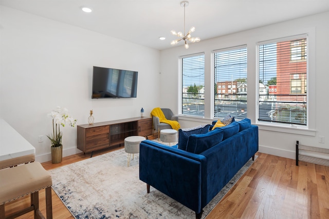 185 Gates Ave, Jersey City, NJ 07305 - living area featuring baseboards, recessed lighting, wood finished floors, and a notable chandelier