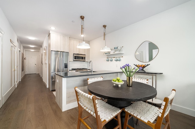 386 5th St Unit 404, Jersey City, NJ 07302 - kitchen featuring appliances with stainless steel finishes, dark wood-style flooring, dark countertops, and modern cabinets