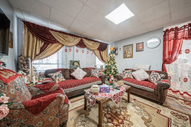 living room with a paneled ceiling