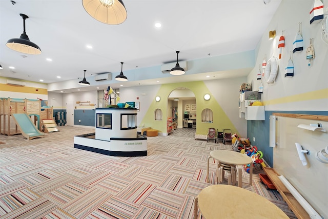 1500 Washington St Unit 8N, Hoboken, NJ 07030 - recreation room featuring recessed lighting, a wall mounted AC, arched walkways, carpet, and a ceiling fan