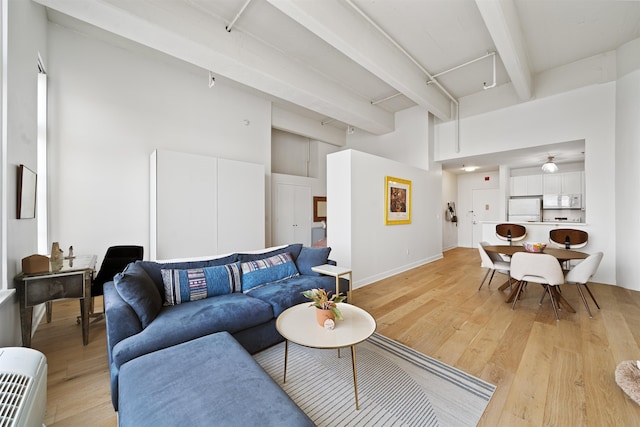 1500 Washington St Unit 8N, Hoboken, NJ 07030 - living area featuring beamed ceiling, light wood-style floors, and a high ceiling