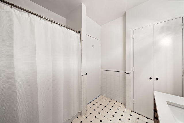 1500 Washington St Unit 8N, Hoboken, NJ 07030 - bathroom featuring tile walls, vanity, wainscoting, and a shower with shower curtain