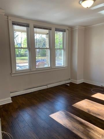 798 Grand St, Jersey City, NJ 07304 - empty room featuring baseboard heating and wood-type flooring