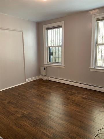 798 Grand St, Jersey City, NJ 07304 - unfurnished room featuring a baseboard radiator and dark wood-style flooring