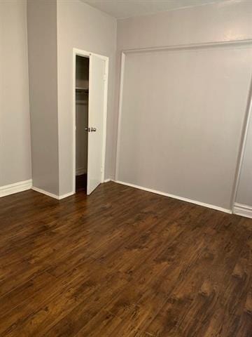 798 Grand St, Jersey City, NJ 07304 - unfurnished bedroom with dark wood-type flooring and baseboards