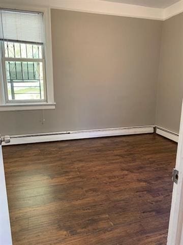 798 Grand St, Jersey City, NJ 07304 - spare room featuring dark wood-type flooring and a baseboard heating unit