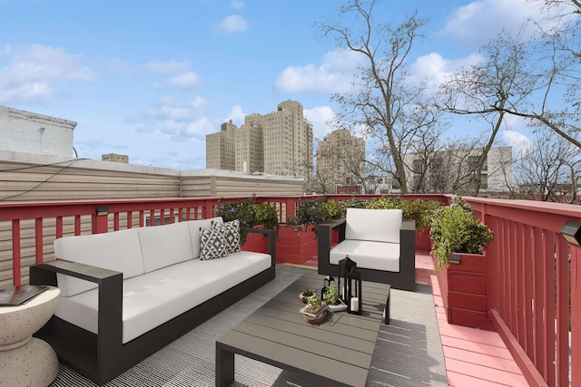 wooden deck featuring outdoor lounge area and a city view