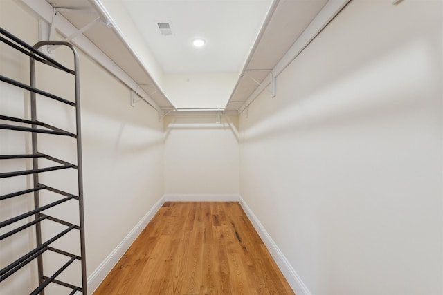 spacious closet with light wood finished floors and visible vents