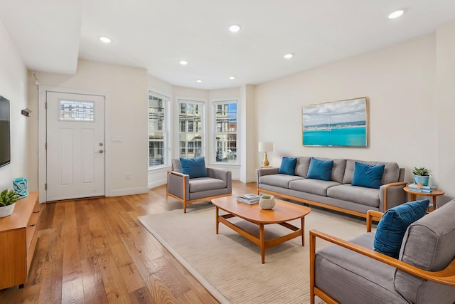 living room featuring recessed lighting, light wood-style floors, and baseboards