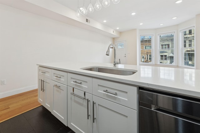 kitchen featuring beverage cooler, recessed lighting, a sink, dark wood-type flooring, and white cabinetry