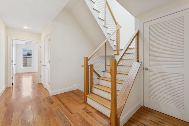 stairway featuring wood finished floors and baseboards