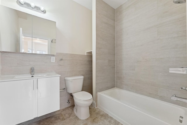 bathroom with vanity, shower / tub combination, tile walls, toilet, and tile patterned floors