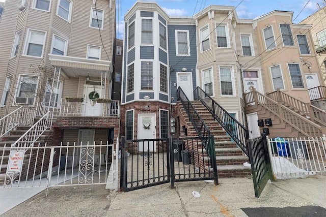 view of property with a fenced front yard and stairs