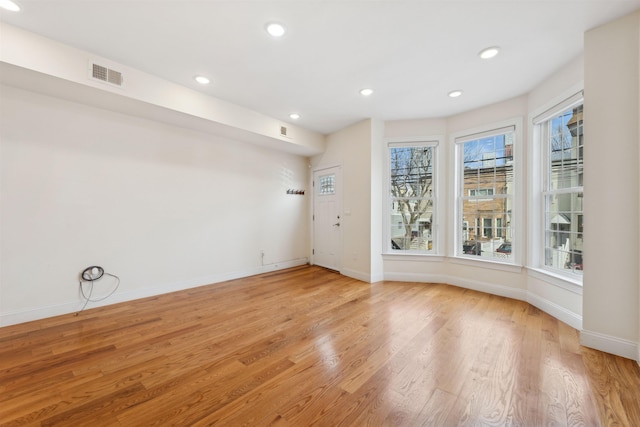 unfurnished room with baseboards, recessed lighting, visible vents, and light wood-type flooring