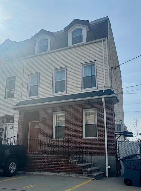 view of front of home featuring uncovered parking and brick siding