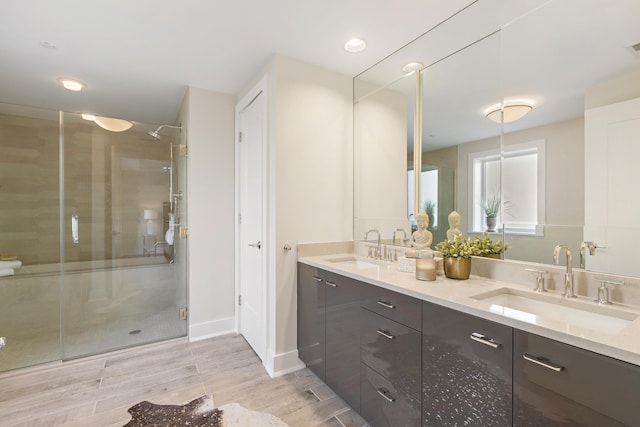 150 Henley Pl Unit 201, Weehawken, NJ 07086 - full bathroom featuring double vanity, a stall shower, wood finished floors, and baseboards