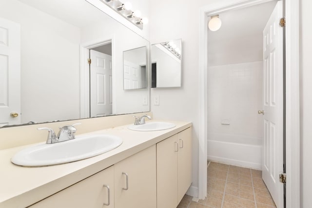 full bath featuring tile patterned floors, a sink, and double vanity