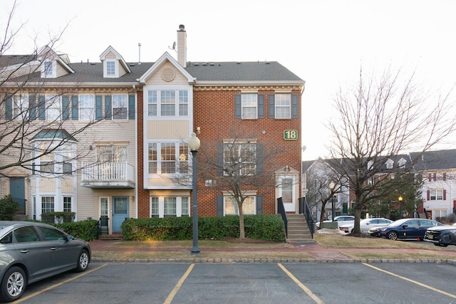 view of building exterior featuring uncovered parking