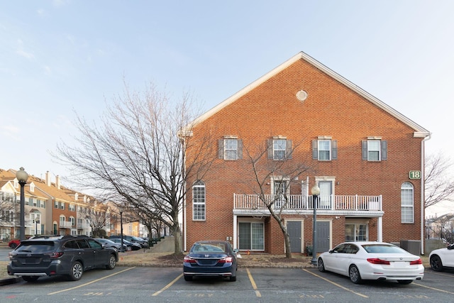 view of building exterior with uncovered parking