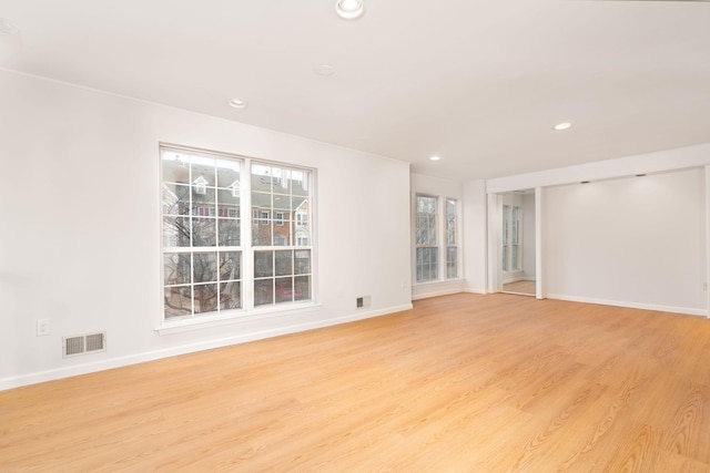 unfurnished room featuring recessed lighting, visible vents, light wood-style flooring, and baseboards