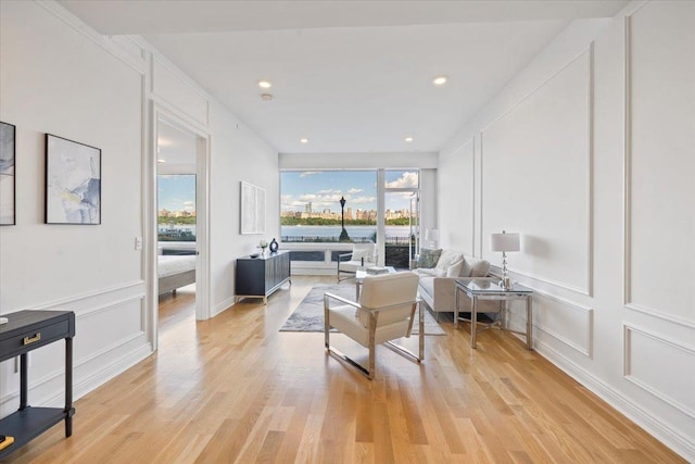 9 Somerset Ln Unit 118, Edgewater, NJ 07020 - living room with a decorative wall, light wood finished floors, and recessed lighting
