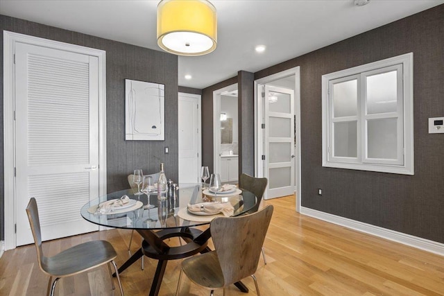 9 Somerset Ln Unit 118, Edgewater, NJ 07020 - dining room featuring wallpapered walls, light wood-style floors, and baseboards