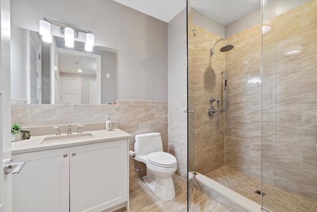 9 Somerset Ln Unit 118, Edgewater, NJ 07020 - full bathroom featuring tiled shower, vanity, toilet, tile walls, and wainscoting