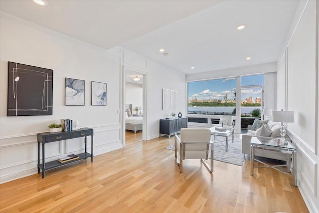 9 Somerset Ln Unit 118, Edgewater, NJ 07020 - living area featuring a decorative wall, light wood finished floors, recessed lighting, and ornamental molding