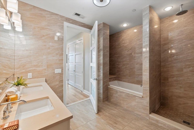 9 Somerset Ln Unit 118, Edgewater, NJ 07020 - full bathroom with double vanity, a tile shower, a bath, tile walls, and tile patterned flooring