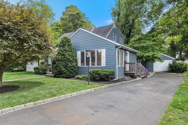 11 Dean Ct, Rutherford, NJ 07070 - view of front facade with an outdoor structure, a front yard, a detached garage, and a shingled roof
