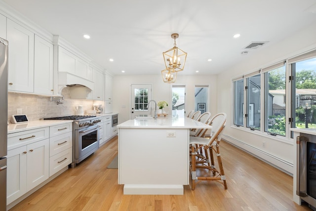 11 Dean Ct, Rutherford, NJ 07070 - kitchen with stainless steel appliances, light wood-style flooring, light countertops, white cabinetry, and recessed lighting